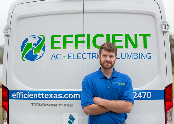 Efficient AC, Electric & Plumbing electrician Steven Schexnayder standing in front of his work truck.