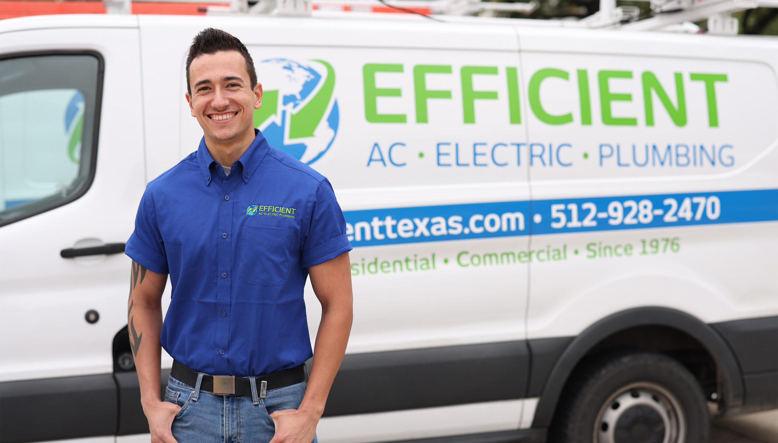 efficient ac electric & plumbing electrician in a blue work shirt and blue jeans standing in front of white work truck