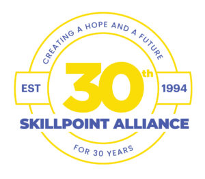 Blue and yellow logo for Skillpoint Alliance, an Austin nonprofit that provides job training.