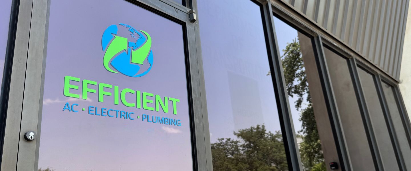 Efficient AC, Electric & Plumbing's front door in Austin, marked with a blue and green logo with a globe.